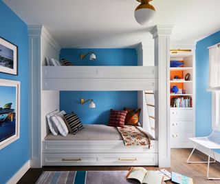 kid's room blue walls and bunks with column detail