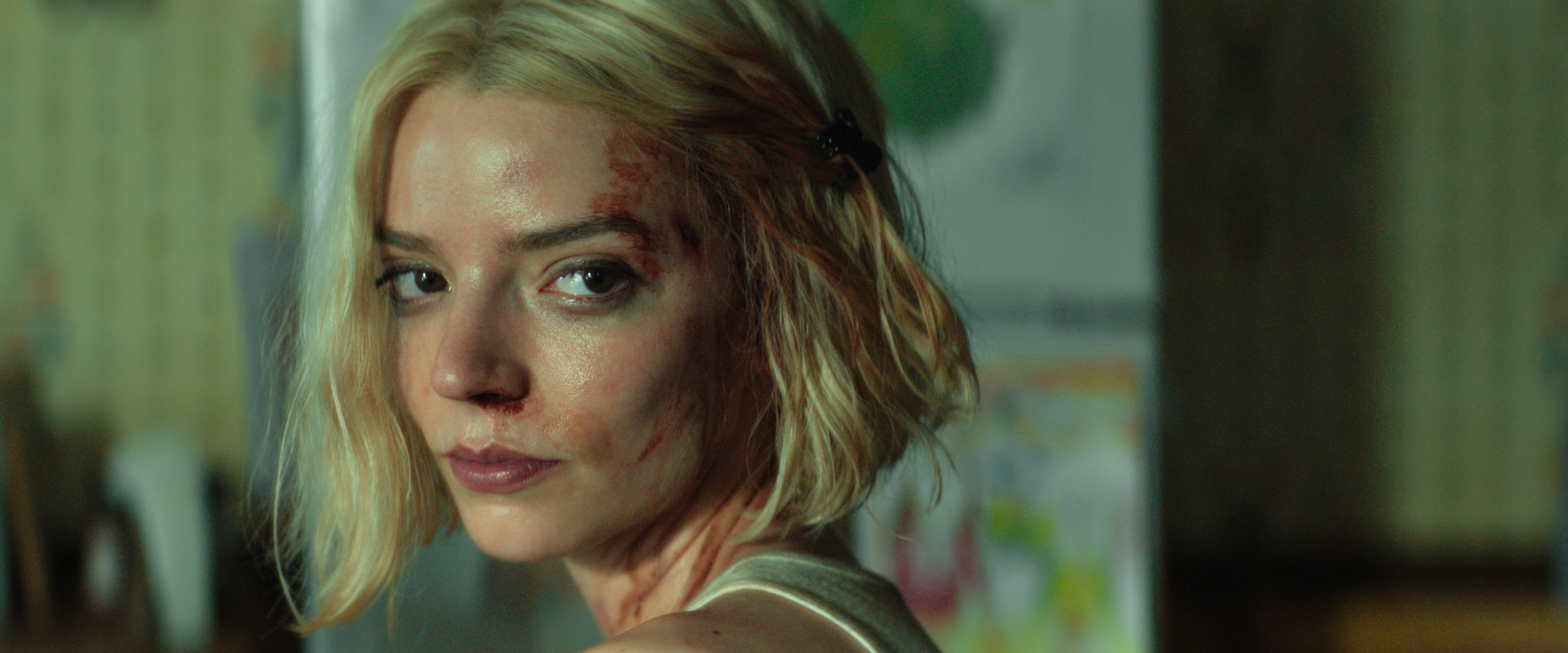 anya taylor joy as lucky looking upset with the side of her face bloody in a still from the premiere of apple tv's lucky