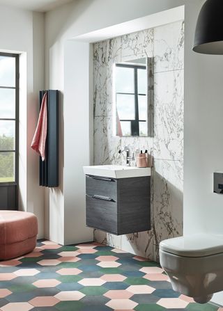 bathroom showing basin unit, bathroom mirror, green, pink and grey hexagonal floor tiles