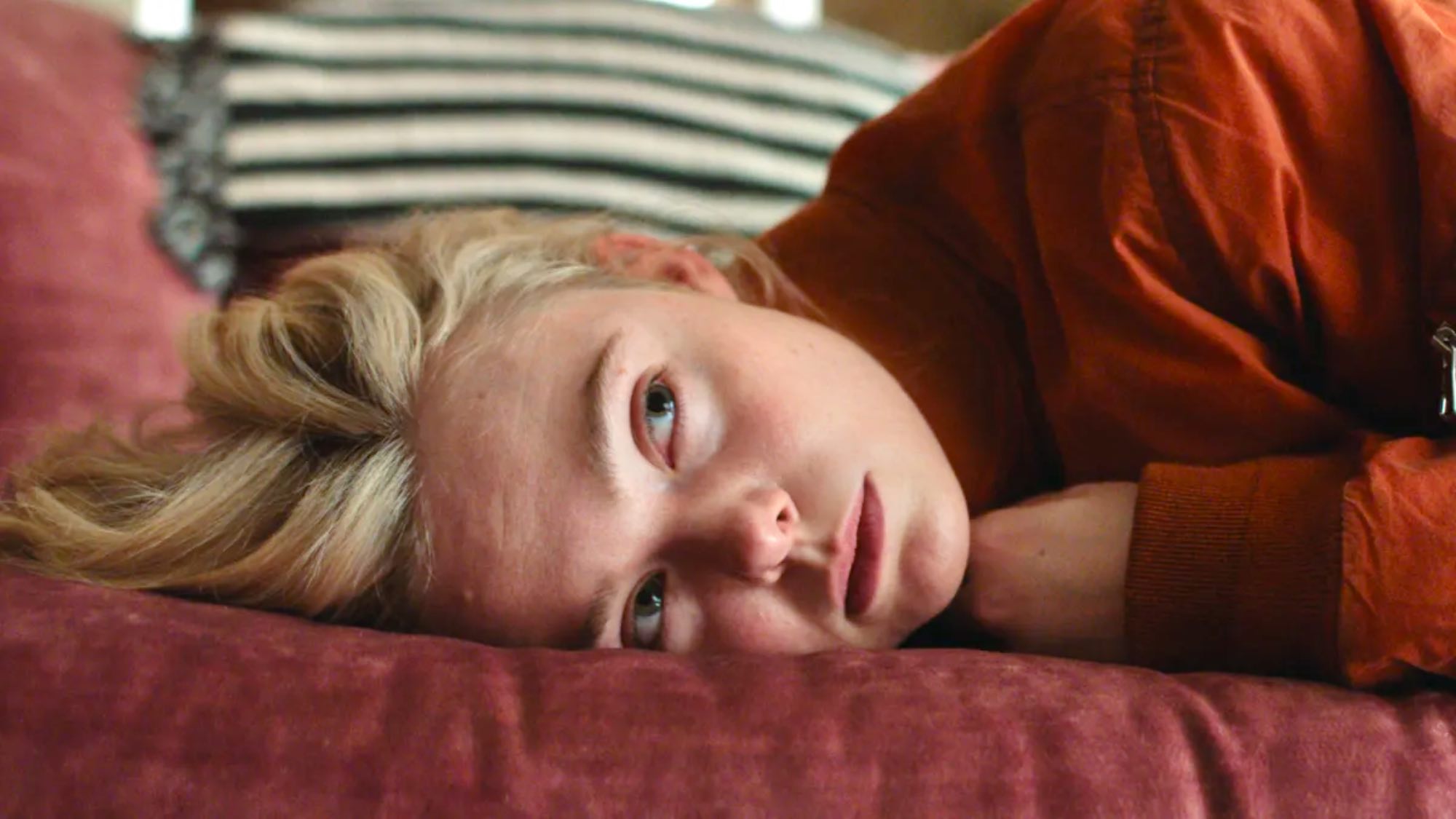 Margo (Elle Fanning) lying on her side in a scene from Apple TV's "Margo's Got Money Troubles"