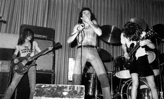 (from left) AC/DC's Malcolm Young, Bon Scott and Angus Young perform live in 1976