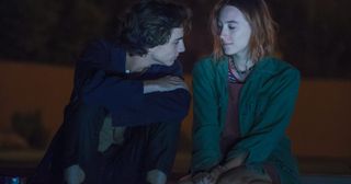 timothee chalamet as kyle and saoirse ronan as lady bird sitting by a pool at night in the movie lady bird