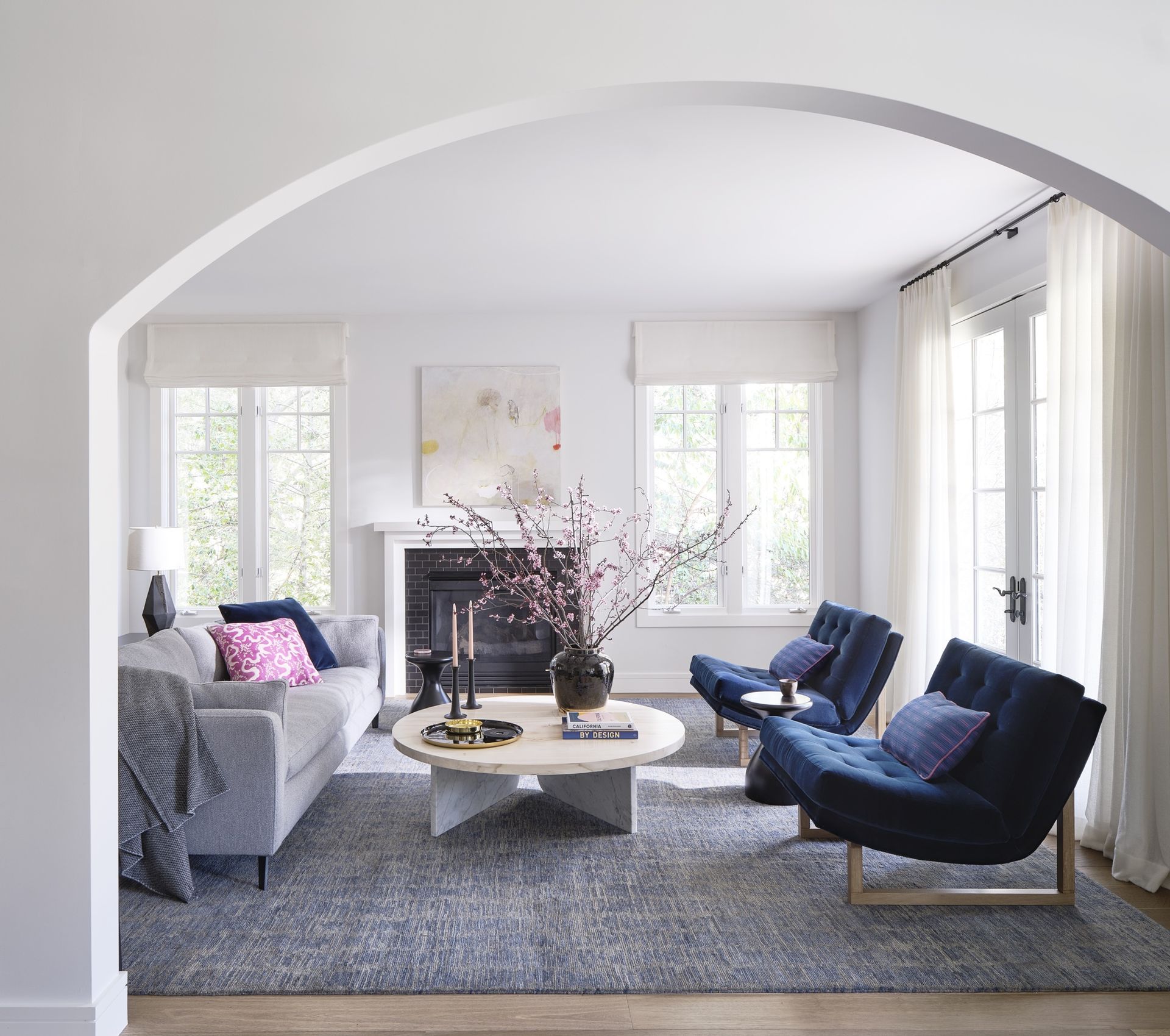 small living room with blue accent chairs by K Interiors