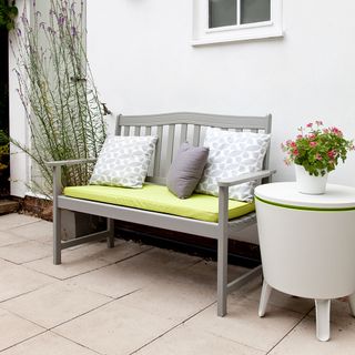 grey sofa with cushion and white wall