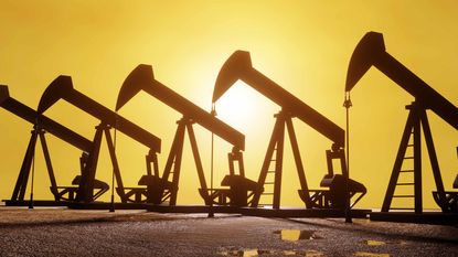 silhouettes of petroleum wells collecting crude at sunset