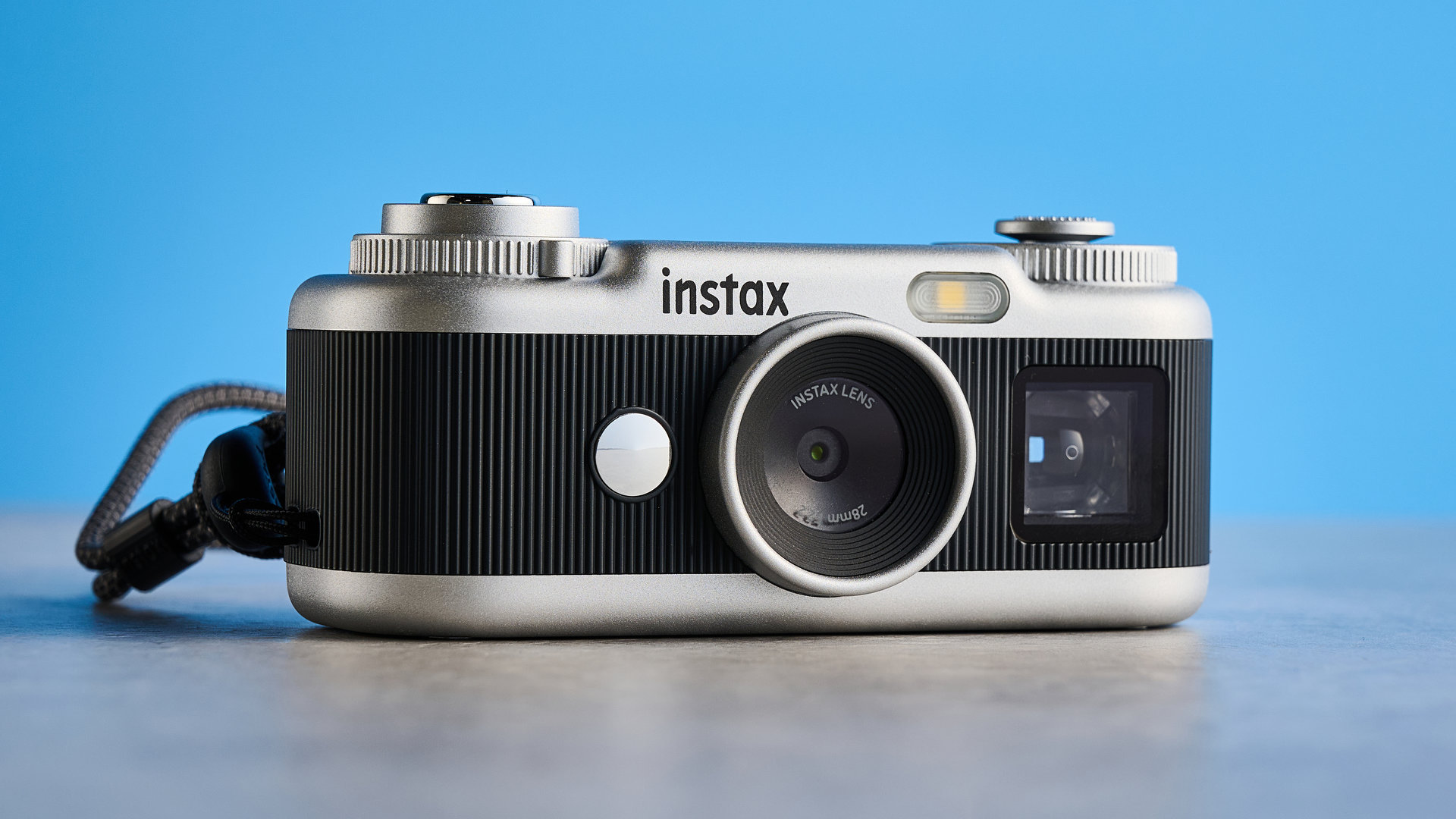 A black and silver Fujifilm Instax Pal 2 digital camera
