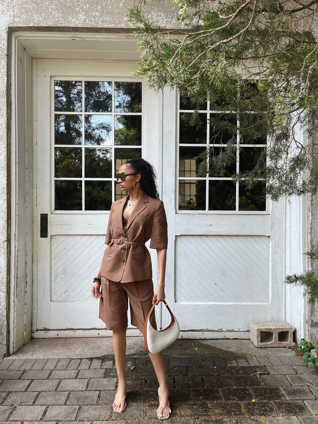 Influencer Kay Ashanti wearing tailored bermuda shorts.