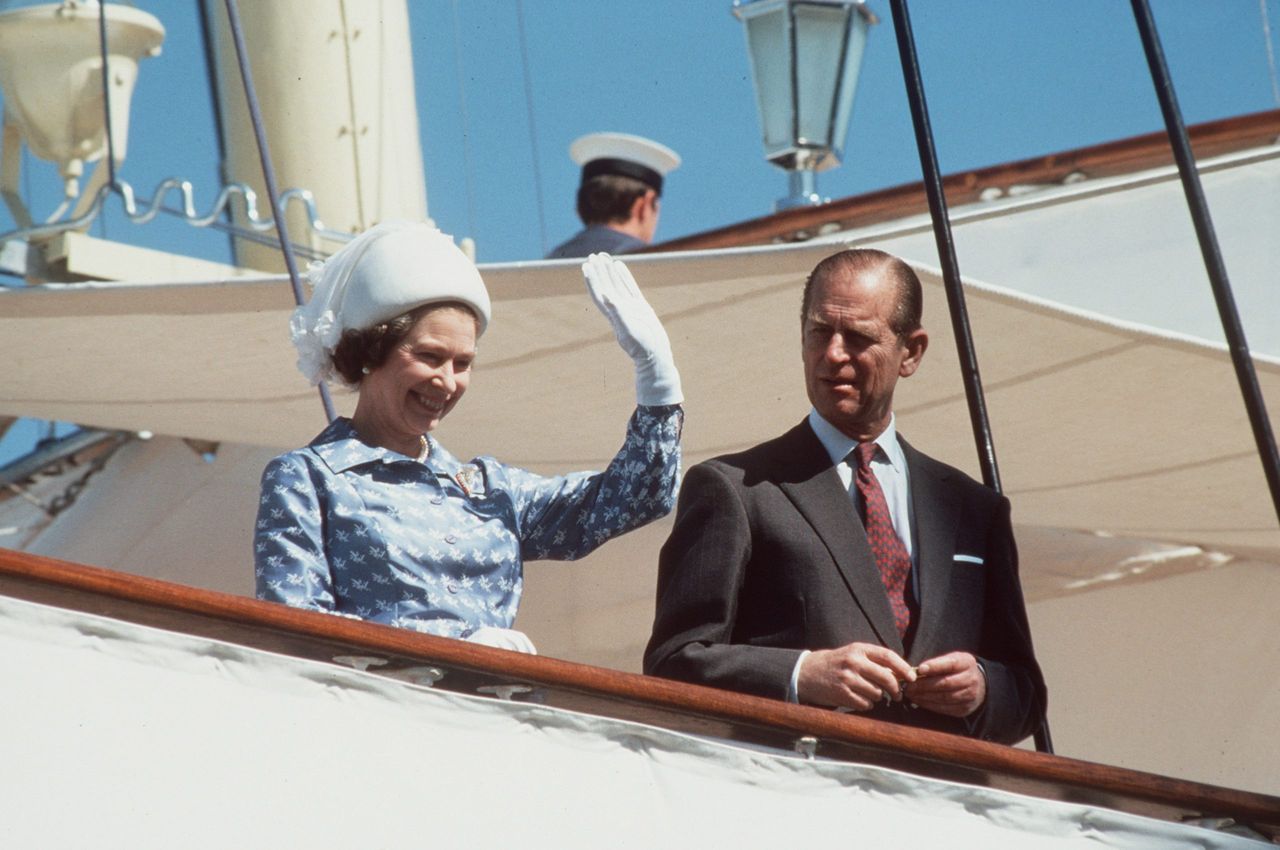 The Queen And Prince Philip waving from on board Royal Yacht Britannia in 1979. Photo by Tim Graham Photo Library.