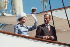 The Queen And Prince Philip waving from on board Royal Yacht Britannia in 1979. Photo by Tim Graham Photo Library.