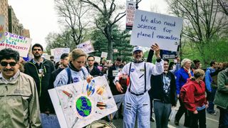 March for Science participants in New York City dress as astronauts to support science.