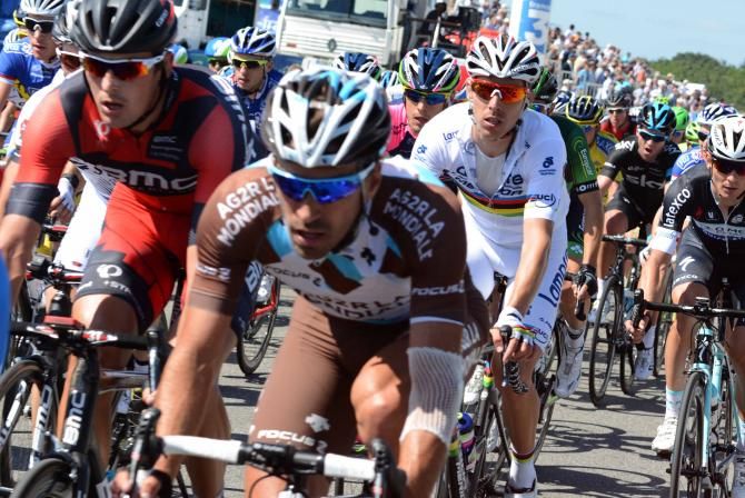 Rui Costa in the rainbow jersey sits in the bunch