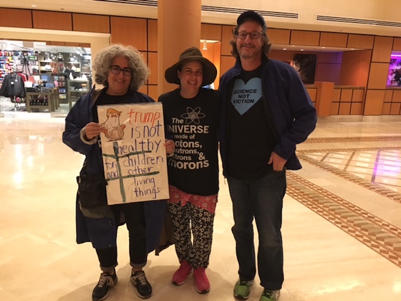 Physician Sam Bender (right) prepares for the March for Science with his wife, Ellen (left), who says she is the mother of a future scientist.