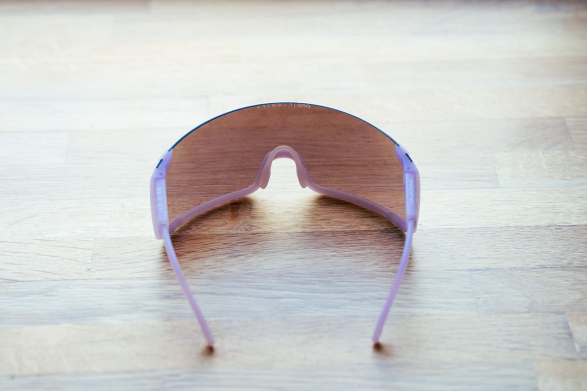 A space-age looking pair of wraparound cycling glasses on a wooden surface