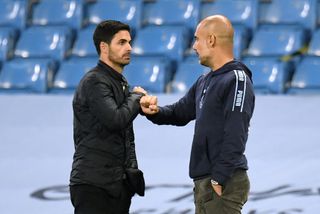 Manchester City manager Pep Guardiola, right, was facing his old assistant Mikel Arteta