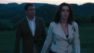 Anne Hathaway in a white leather jacket walking away from Steve Carell in Get Smart