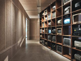 Fadama 40, by Ibrahim Mahama, an installation at the Design Museum consisting of wooden shelving displaying discarded TVs