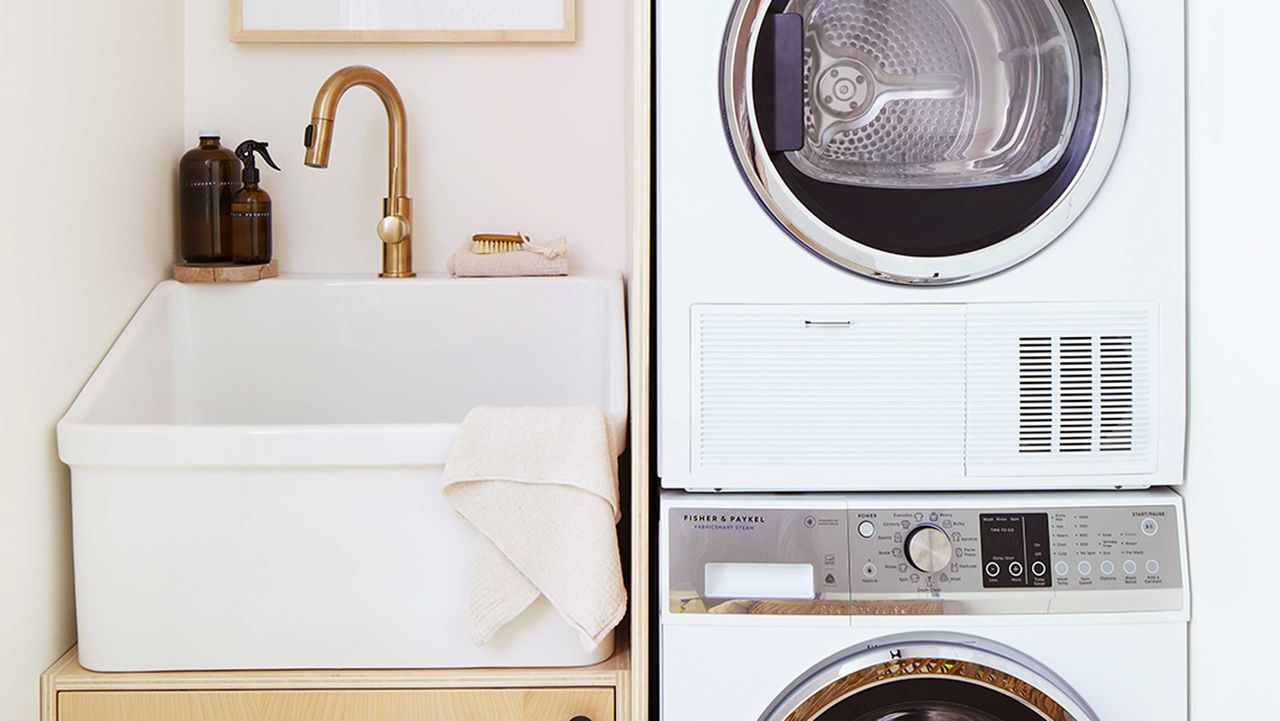 a small laundry room with a sink