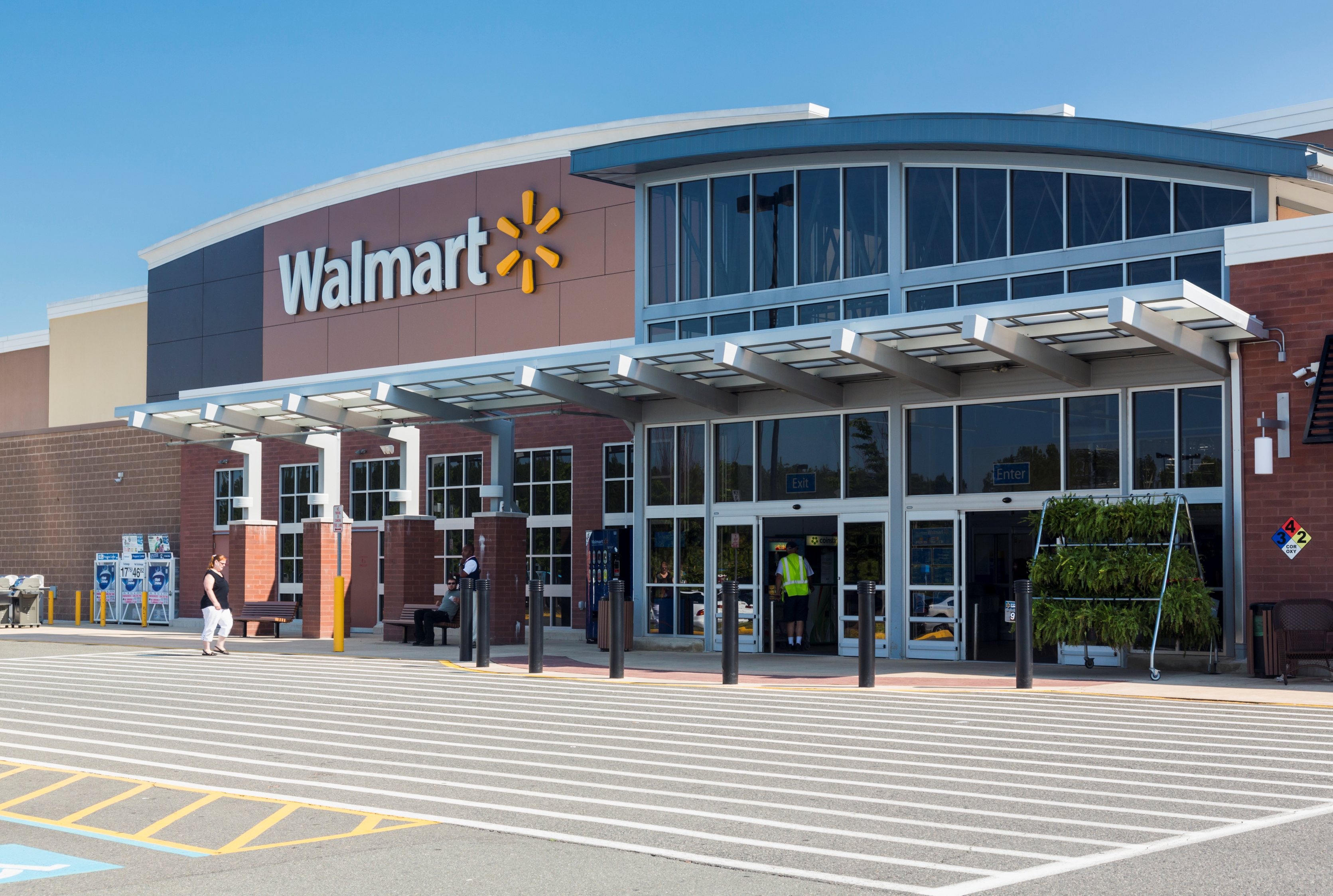 Customers walking into a Walmart store.