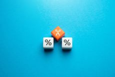 two white die with percentage symbols in between an orange die with scissors and blue background