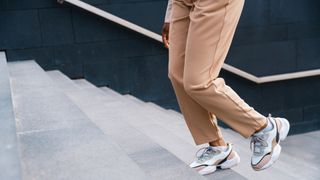 woman walking up stairs in trainers