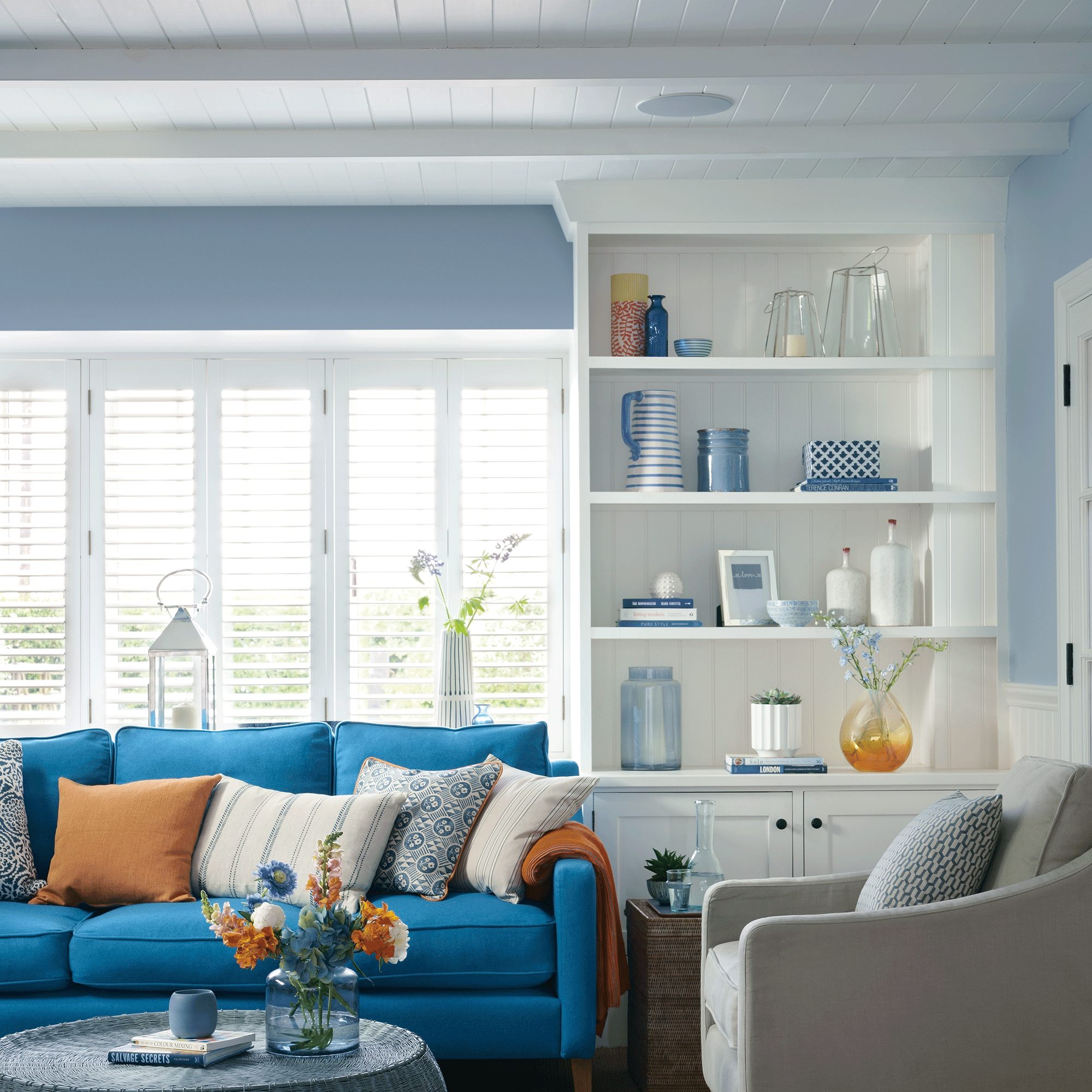 White and blue living room with shiplap ceiling