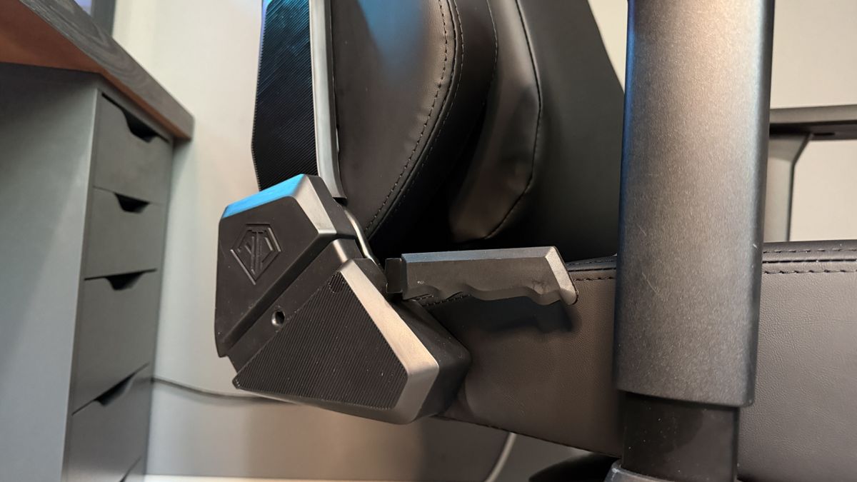 The AndaSeat Phantom 4 Pro in a brightly lit home office environment in front of a gaming PC.