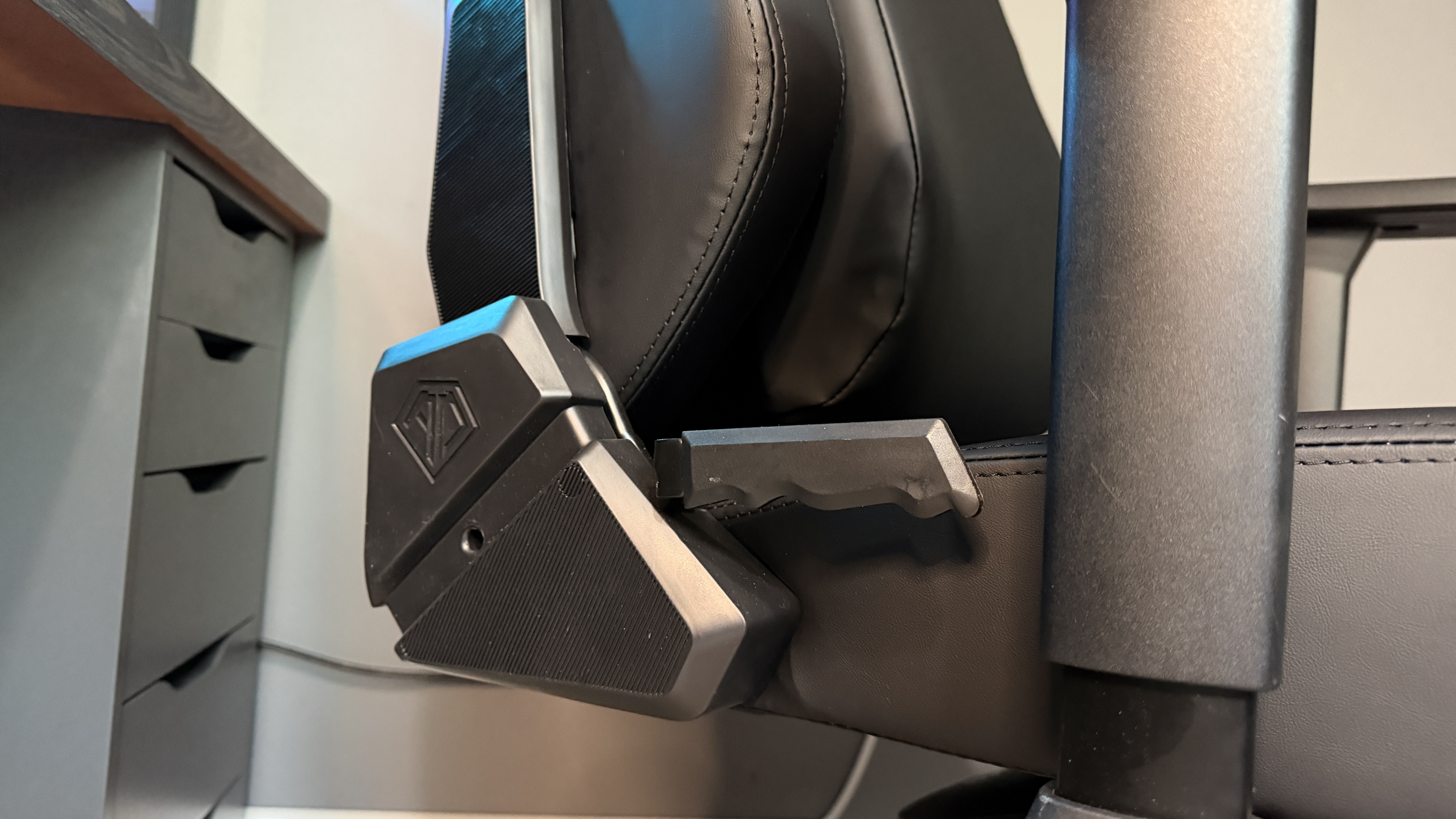 The AndaSeat Phantom 4 Pro in a brightly lit home office environment in front of a gaming PC.