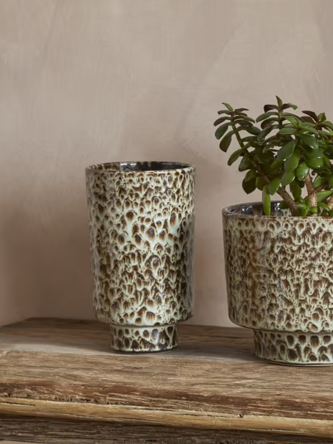 A marbled vase from nkuku beside a matching pot on a wood table