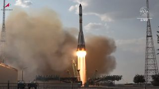 A white and green Soyuz rocket lifts off from Baikonur Cosmodrome on a cloudy evening on May 24, 2023