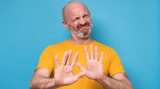 A man holds his hands up as if to say, "Please stop."