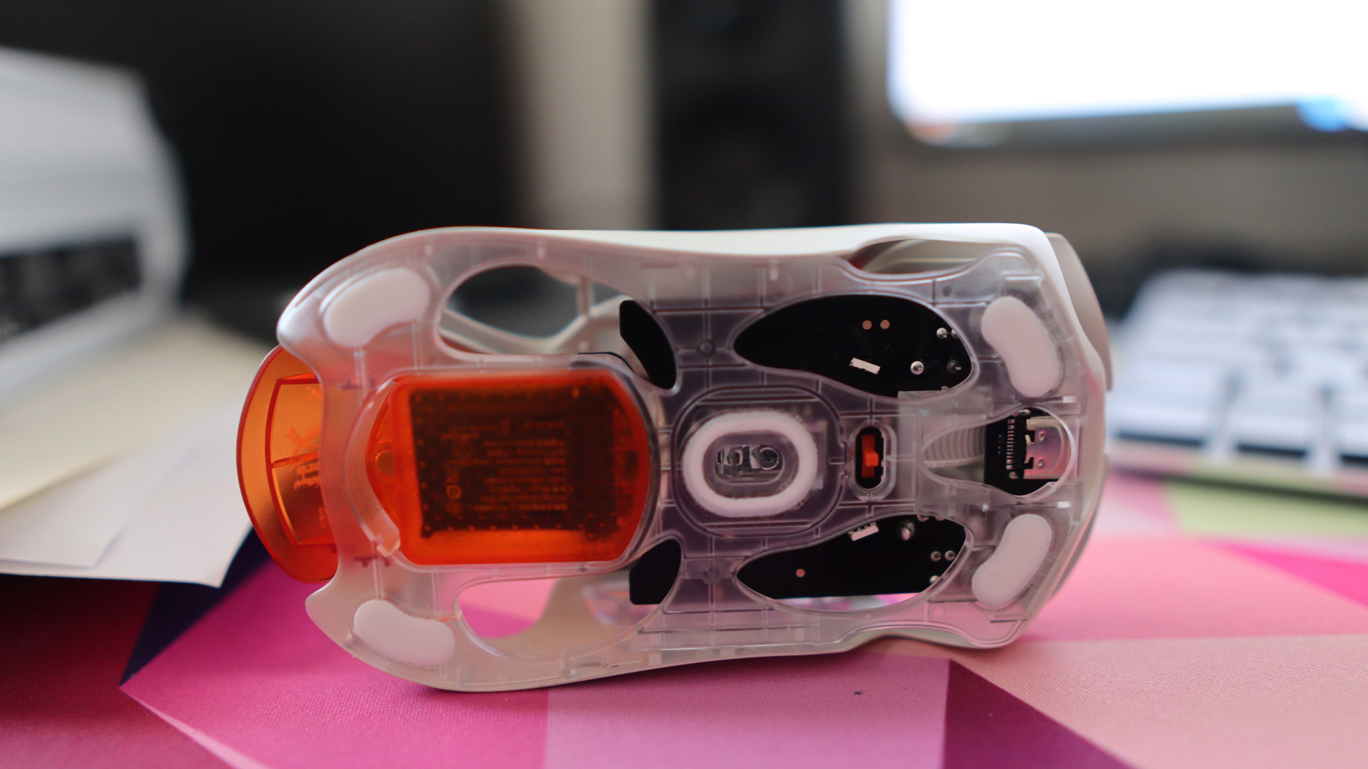AngryMiao AM Infinity.97 gaming mouse on a colorful desk