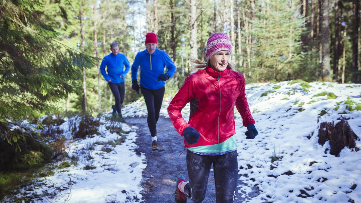 Joggers on a snowy trail run