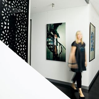 hallway with white walls and women