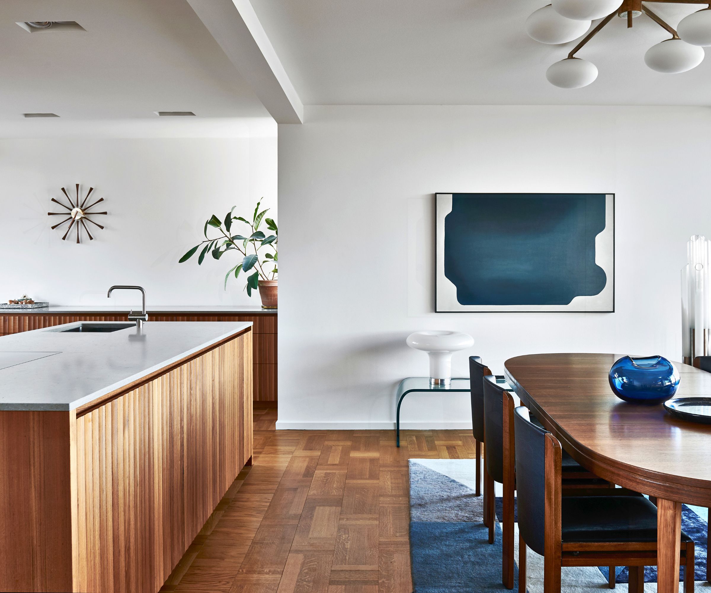 kitchen diner white walls with wood cabinetry