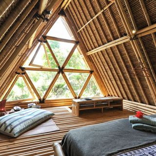 bamboo hut room with pillow and bed