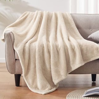 Cream-colored fuzzy throw blanket