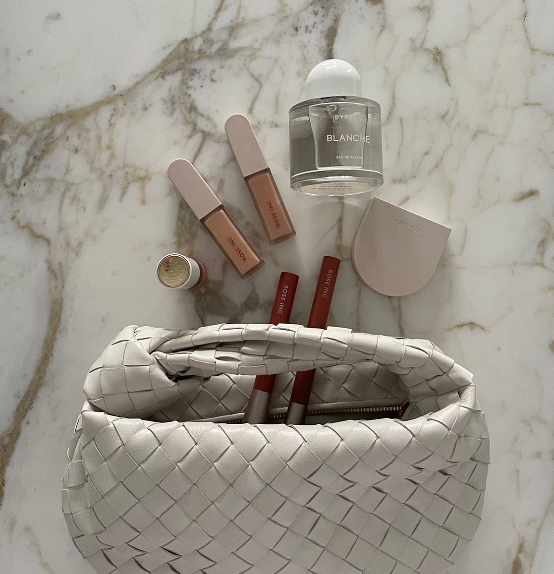 Bottega bag with makeup products inside