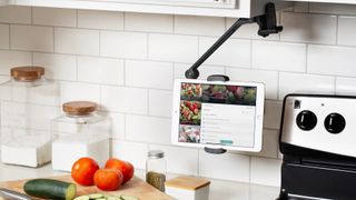iPad on Twelve South HoverBar Duo, one of the best iPad stands in kitchen, holding recipe beside hob and ingredients