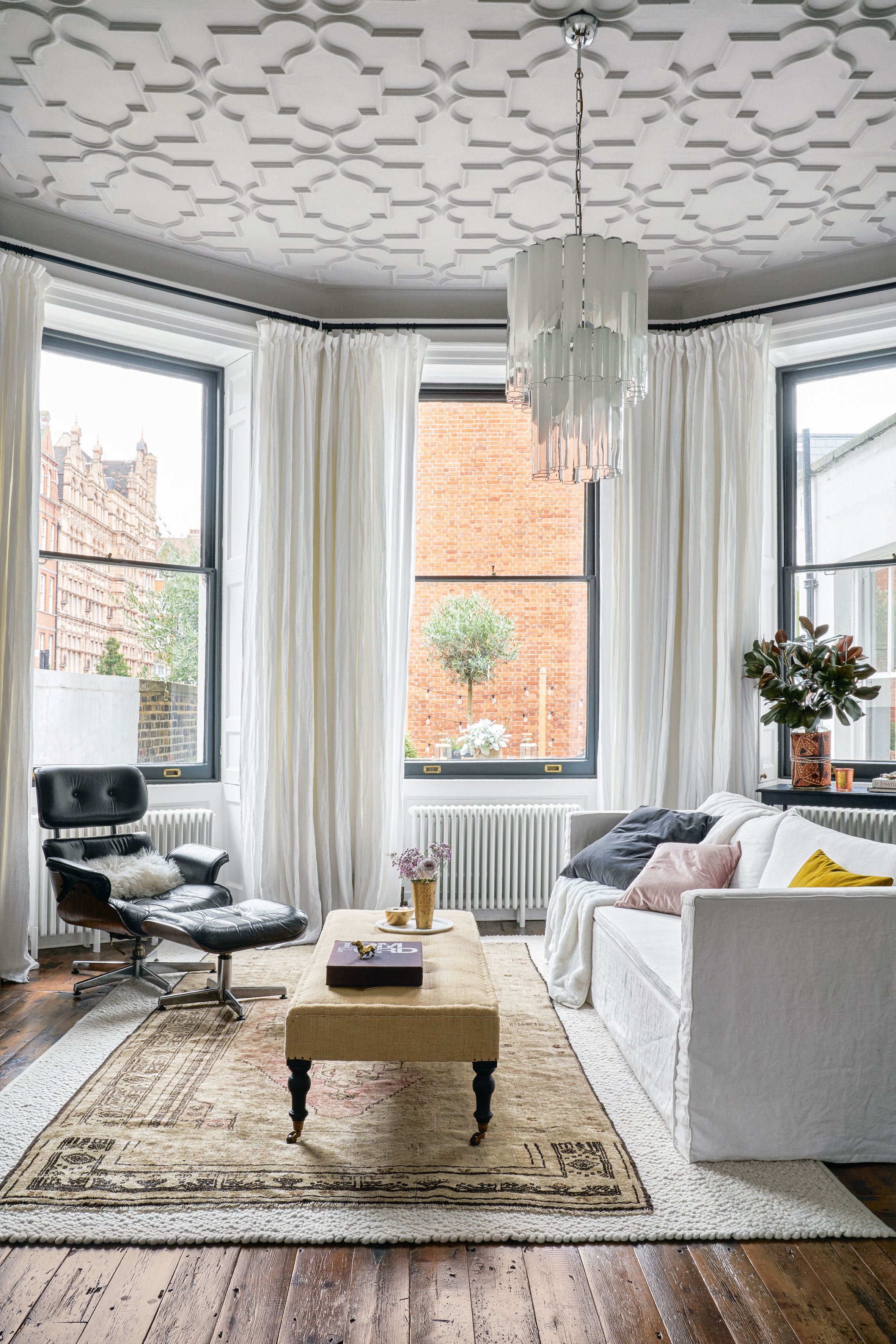 White modern living room with a mix of different style furniture