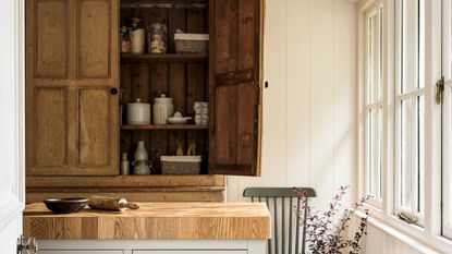 An open wooden pantry in a rustic kitchen