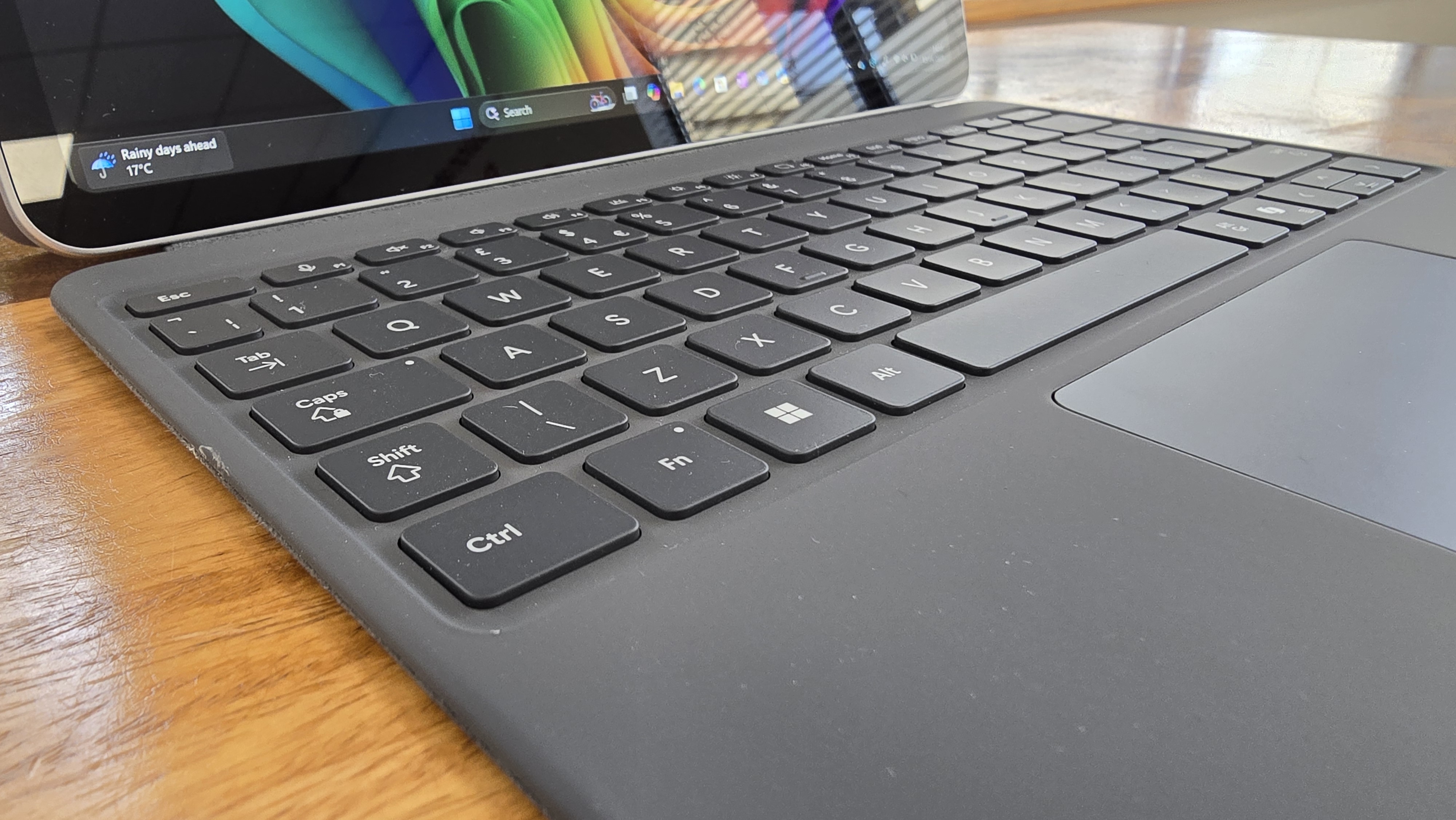 Microsoft Surface Pro 12 tablet on wooden table in relaxed cafe