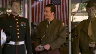 Ethan Embry admires a mannequin in a Marine uniform in That Thing You Do!