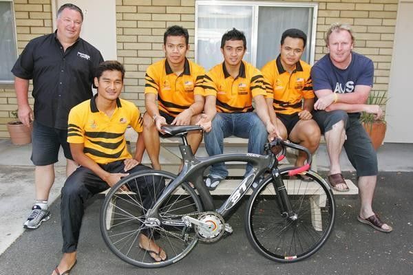 The Malaysian riders, with their Australian coaches and one of the team's bikes.