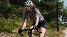 The Paria R-01 short sleeve jersey worn on a rider on a bike with a white helmet and black shorts 