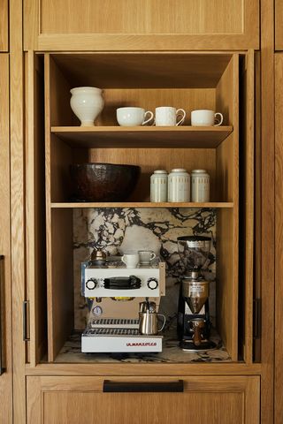coffee niche in a wood cabinets with a pocket door