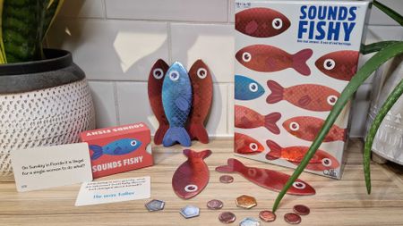 Sounds Fishy box, counters, and cards against a white tile background