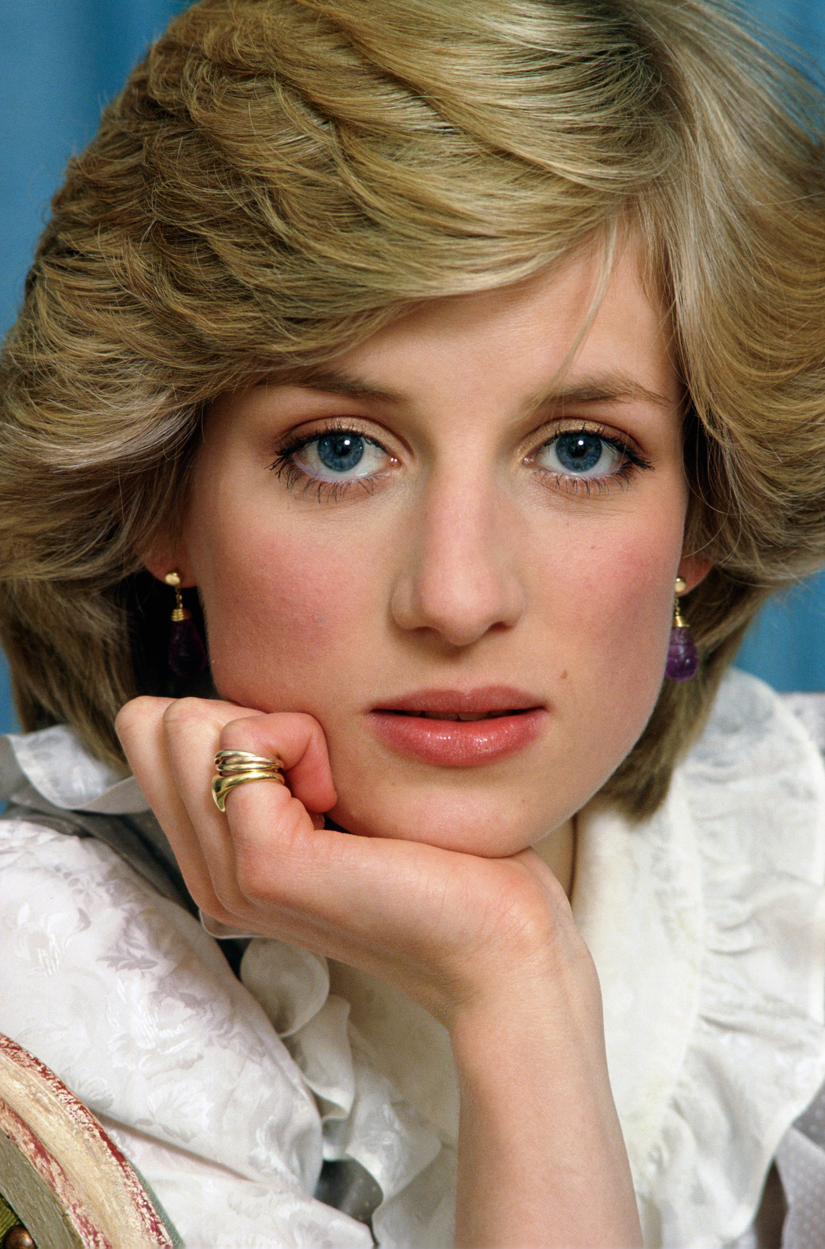 A portrait of Princess Diana putting her hand on her chin