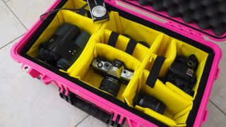 Peli / Pelican 1510 protector case in bright pink on a flagstone floor