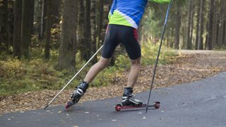 A man goes roller skiing