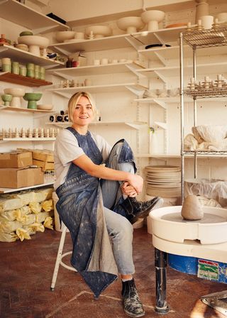 Izzy Letty in her Deptford pottery workshop in London, surrounded by her creations.